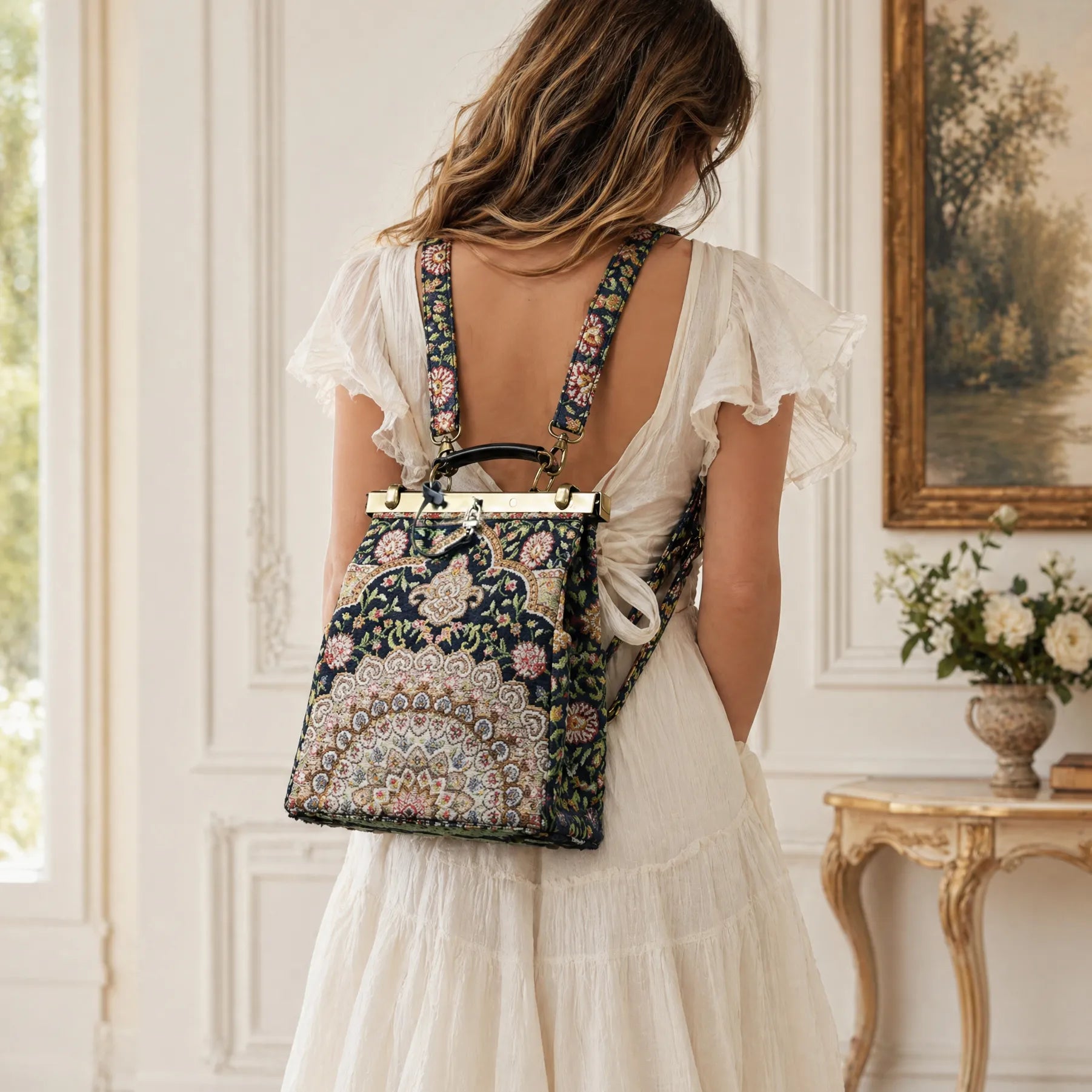 Woman in a white dress wearing an oriental navy helena carpet backpack gladstone bag from the back.