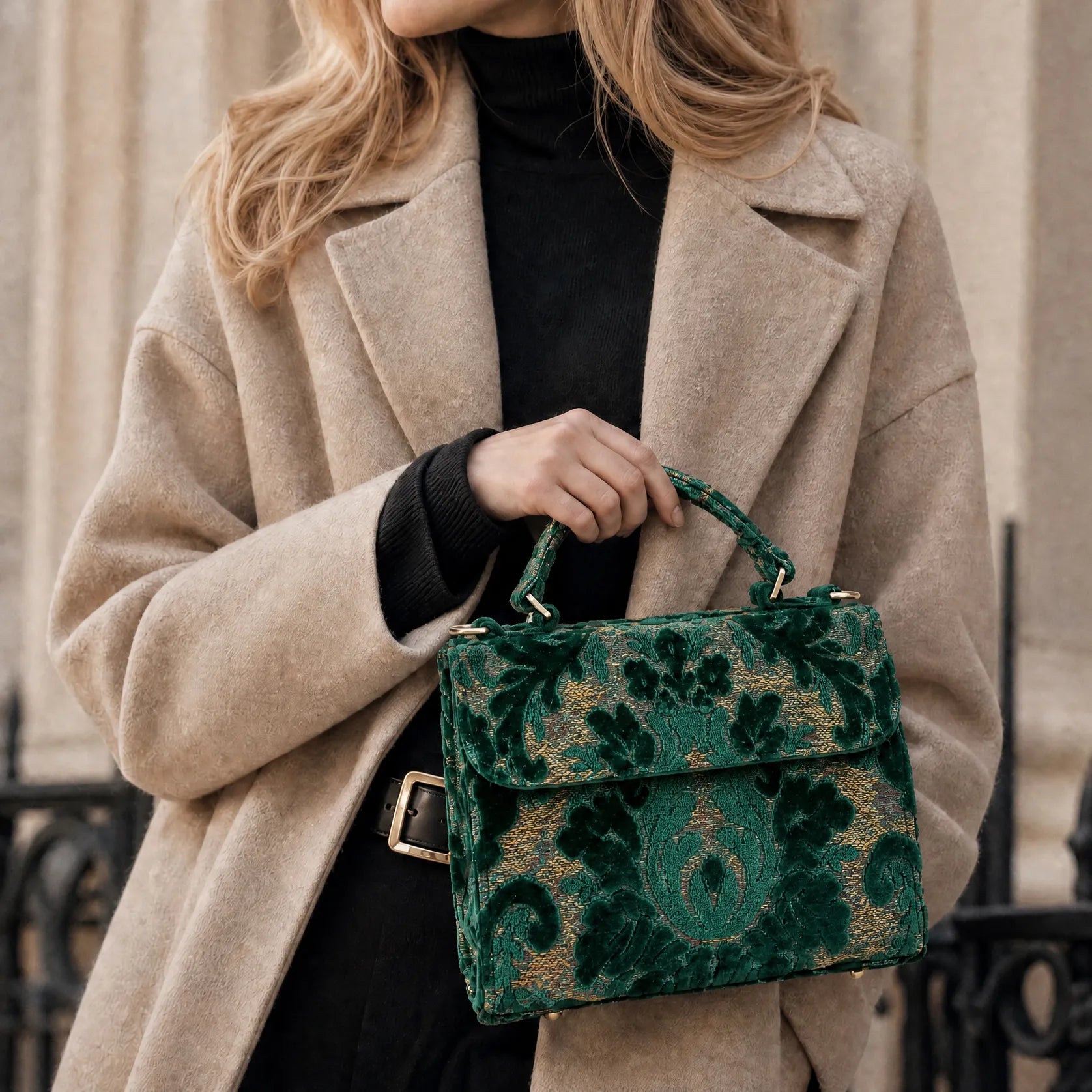 Person wearing a beige coat holding a Burnout Velvet Jade Green patterned handbag.