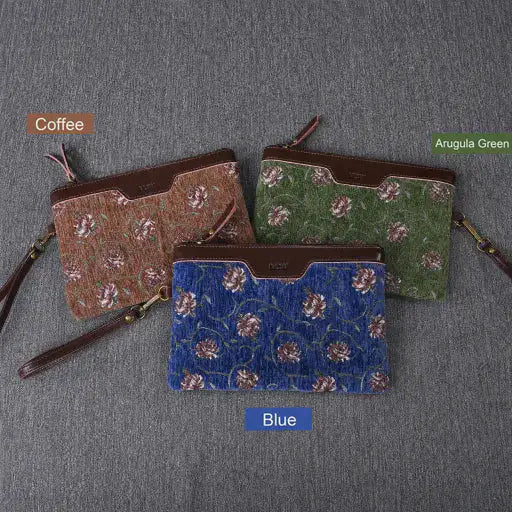 Wristlet Clutch of three floral-patterned pouches in Coffee, Arugula Green, and Blue on a gray background.