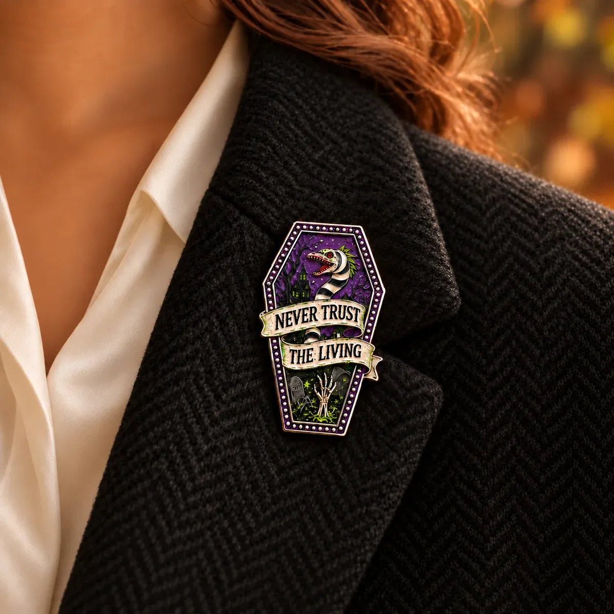 Never Trust the Living Beetlejuice enamel brooch on black tweet jacket