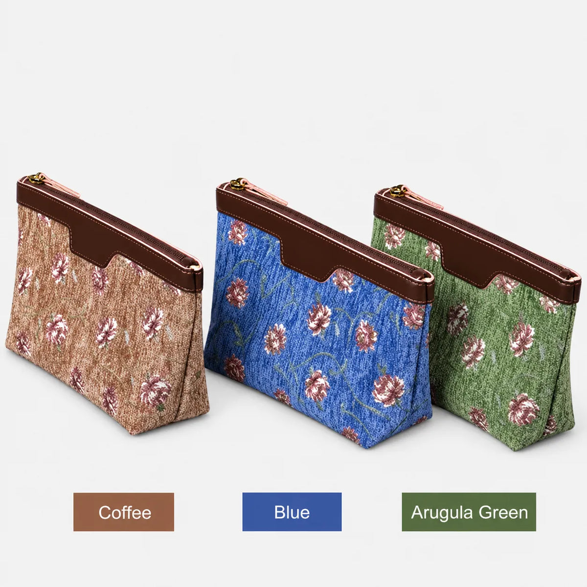 Three floral-patterned carpet makeup bag in Coffee, Blue, and Arugula Green on a gray surface.
