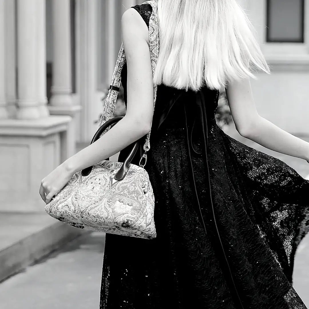 Victorian-inspired chenille carpet handbag worn over the shoulder with an adjustable strap.