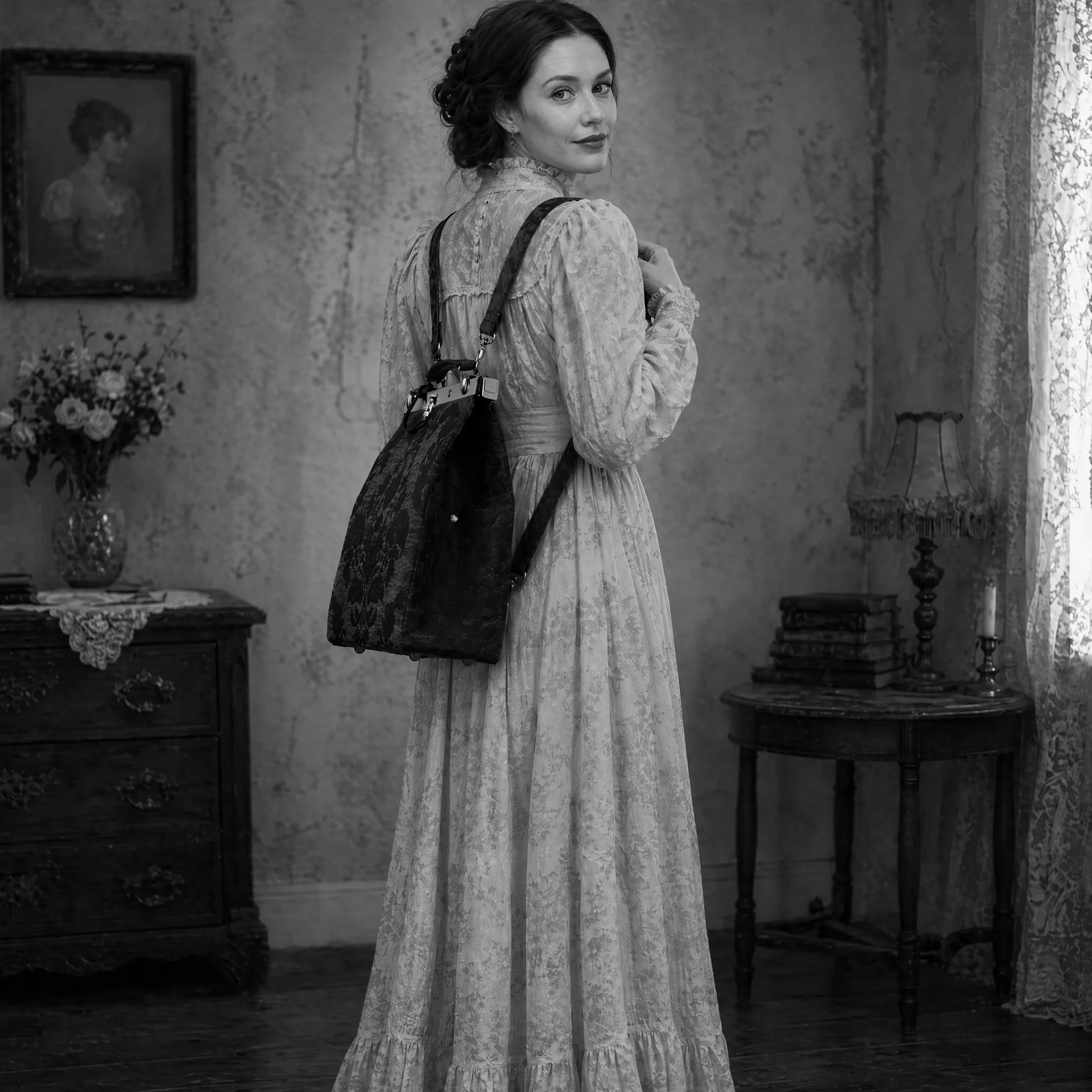Woman in a vintage dress holding a floral Helena Carpet Backpack in an old-fashioned room.