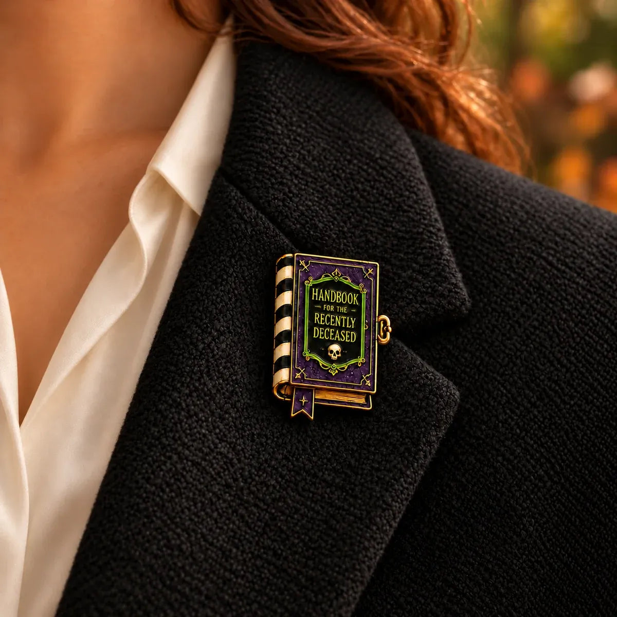 Handbook for the Recently Deceased Beetlejuice enamel brooch on black tweet jacket